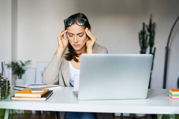 Woman at her laptop looking stressed over her Search Engine Optiimization